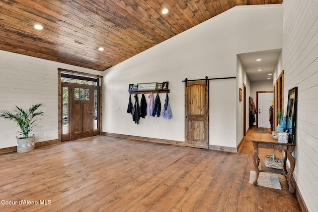 entryway featuring wood-type flooring, high vaulted ceiling, a barn door, wooden ceiling, and recessed lighting
