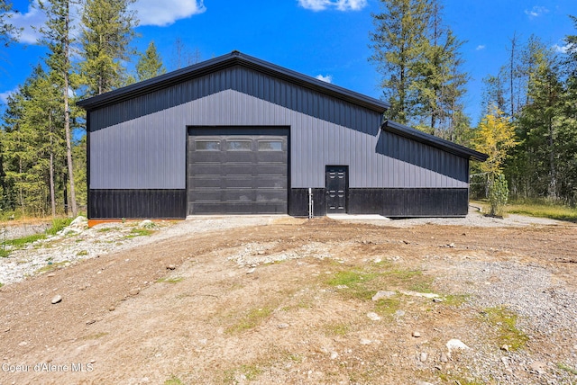 detached garage with dirt driveway