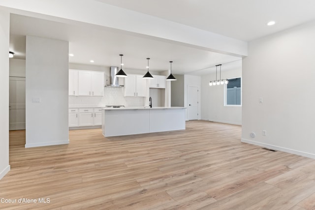 6631 Portrush Dr, Rathdrum, ID 83858 - unfurnished living room with light wood finished floors, baseboards, and recessed lighting