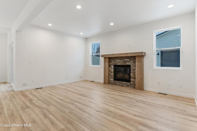 6631 Portrush Dr, Rathdrum, ID 83858 - unfurnished living room featuring visible vents, a fireplace, recessed lighting, and light wood-style flooring