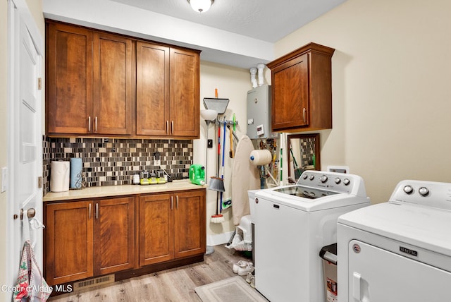 1315 N 10th St, Coeur Dalene, ID 83814 - laundry area featuring washing machine and dryer, light wood finished floors, and cabinet space