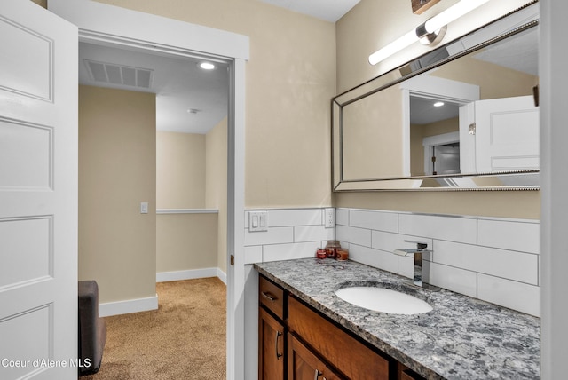 1315 N 10th St, Coeur Dalene, ID 83814 - bathroom with baseboards, vanity, and backsplash