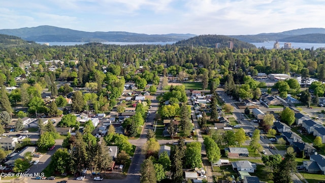 1315 N 10th St, Coeur Dalene, ID 83814 - aerial overview of property's location with a mountainous background and a heavily wooded area