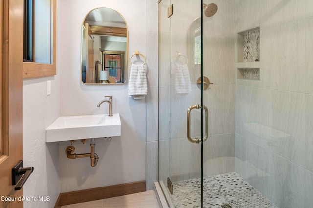 full bathroom with a stall shower and a sink