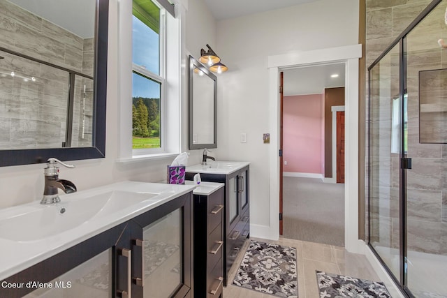 full bath with a stall shower, two vanities, and tile patterned flooring