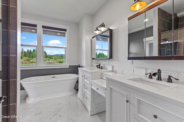 full bath featuring a freestanding bath, vanity, and marble look tiles