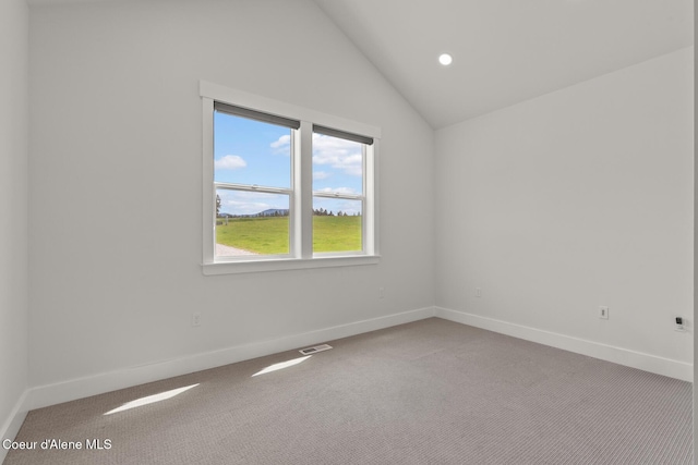carpeted spare room with lofted ceiling, baseboards, and recessed lighting