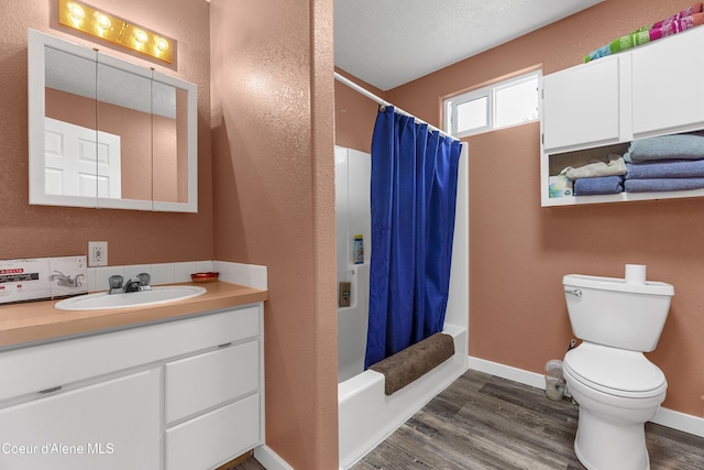 1729 N 9th St, Coeur Dalene, ID 83814 - bathroom with vanity, wood finished floors, toilet, shower / bath combo with shower curtain, and baseboards