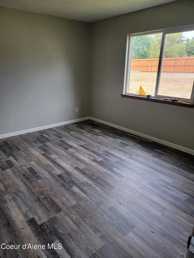 1729 N 9th St, Coeur Dalene, ID 83814 - empty room with dark wood-type flooring