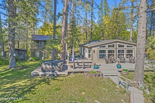 back of property featuring a deck and a yard