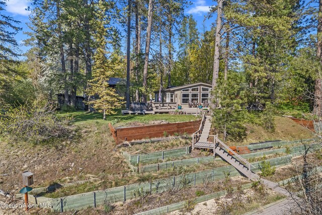 view of yard featuring a garden and a wooden deck