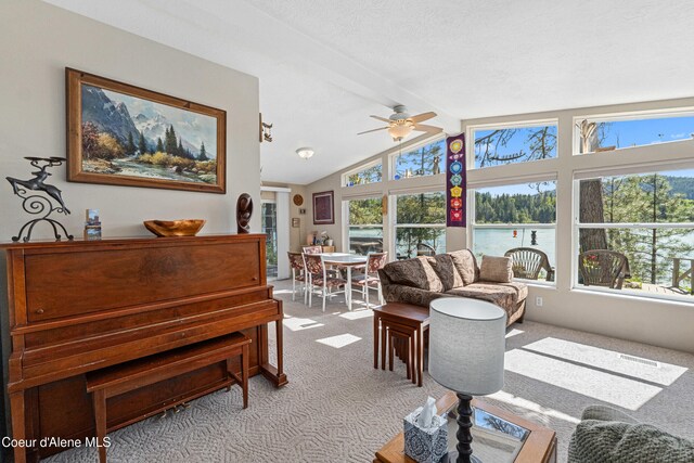 carpeted living area featuring ceiling fan