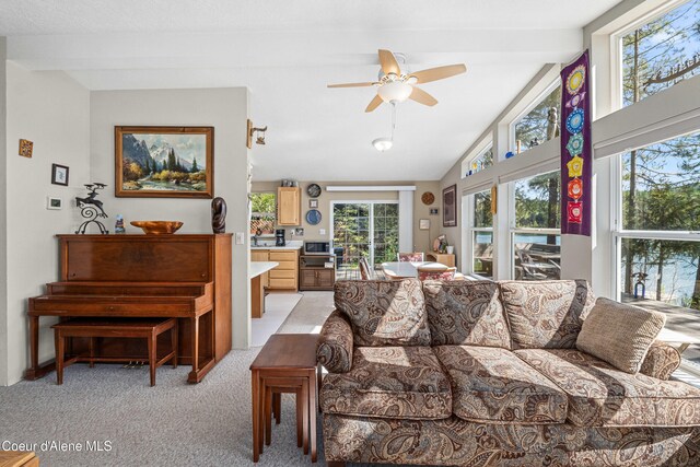 living room with light carpet and ceiling fan