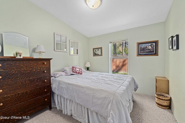 carpeted bedroom with vaulted ceiling