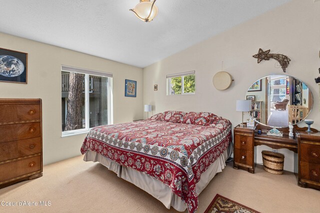 bedroom with carpet and lofted ceiling