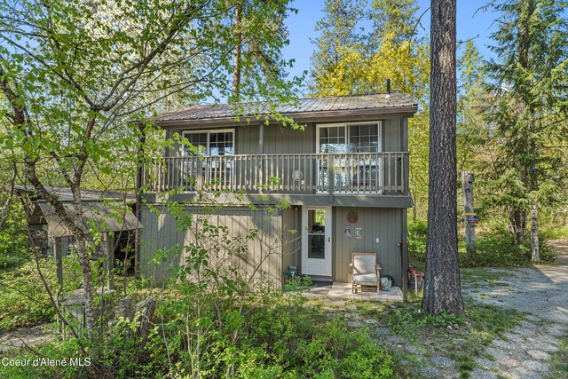 rear view of property with metal roof