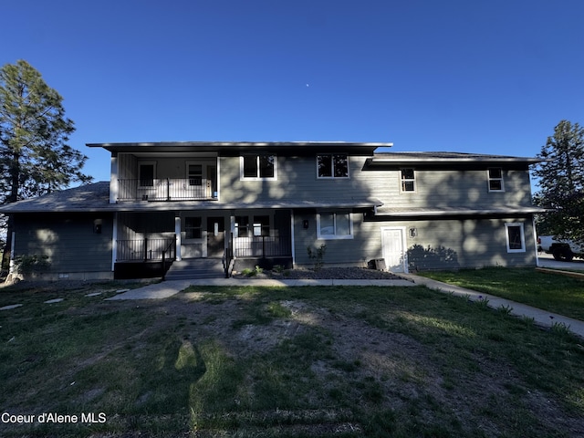 10320 N Payment Peak Rd, Hauser, ID 83854 - back of house featuring covered porch, a yard, and a balcony