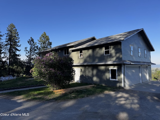 10320 N Payment Peak Rd, Hauser, ID 83854 - view of home's exterior featuring concrete driveway and an attached garage