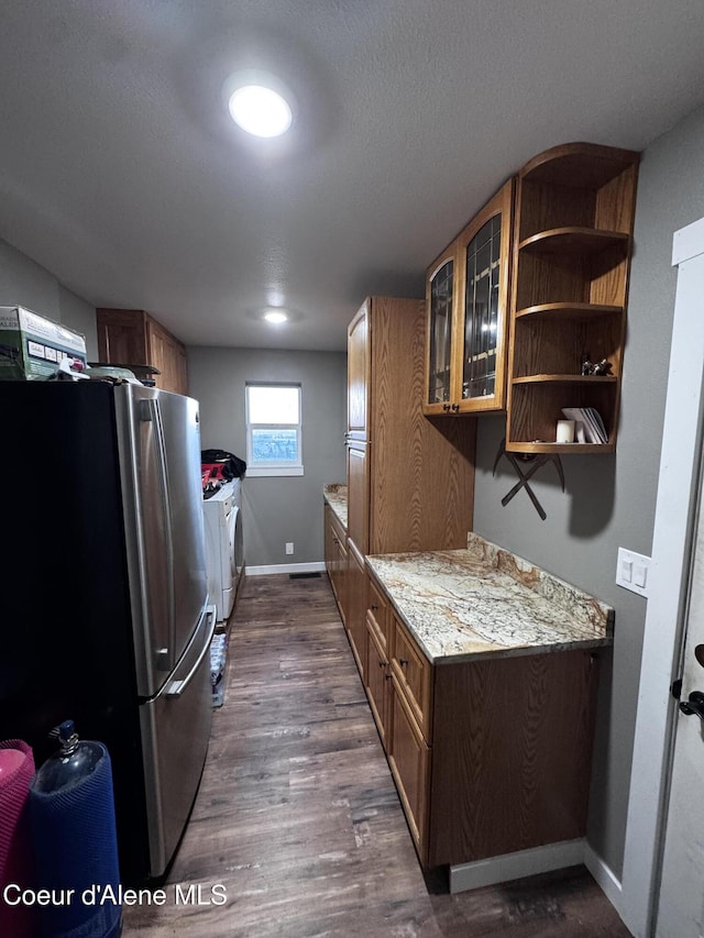 10320 N Payment Peak Rd, Hauser, ID 83854 - clothes washing area featuring baseboards, laundry area, dark wood-style floors, and washer and clothes dryer