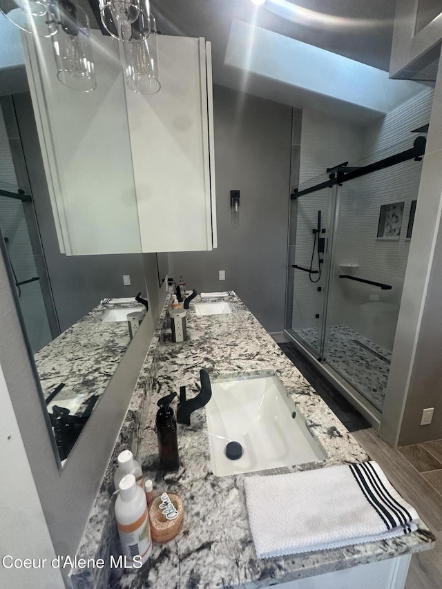 10320 N Payment Peak Rd, Hauser, ID 83854 - bathroom with a sink, double vanity, and a shower stall