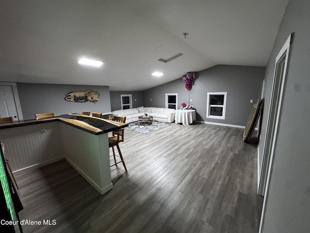 10320 N Payment Peak Rd, Hauser, ID 83854 - kitchen with dark wood finished floors, lofted ceiling, baseboards, and open floor plan