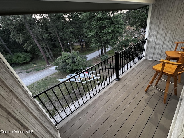 10320 N Payment Peak Rd, Hauser, ID 83854 - wooden deck featuring view of scattered trees