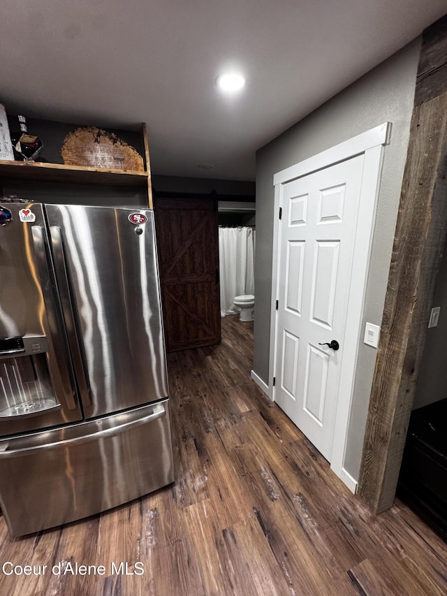 10320 N Payment Peak Rd, Hauser, ID 83854 - kitchen featuring stainless steel refrigerator with ice dispenser, dark wood-type flooring, a barn door, and recessed lighting