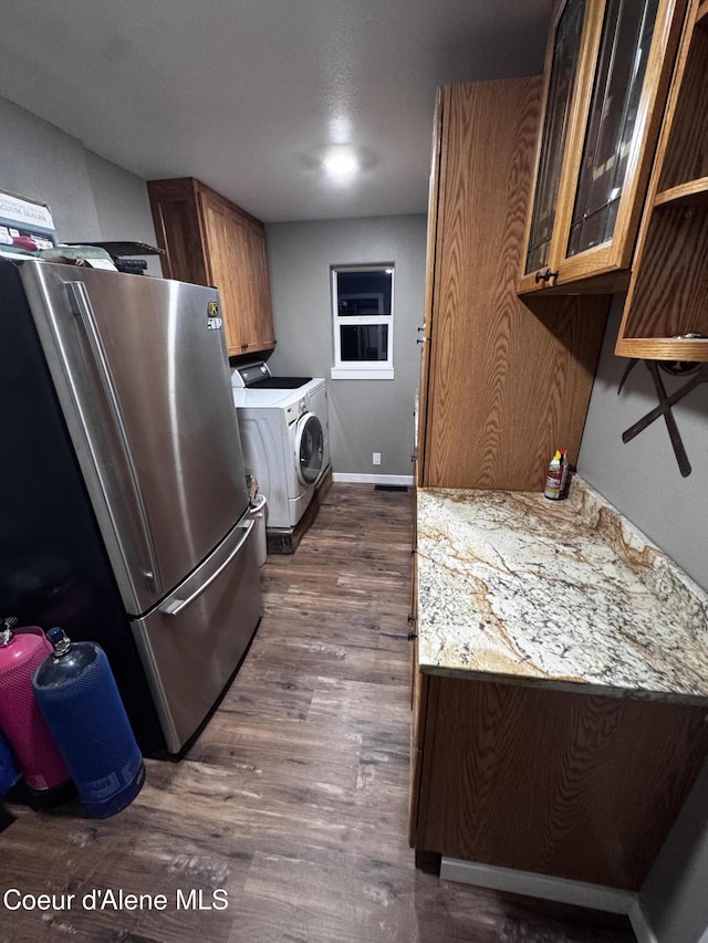 10320 N Payment Peak Rd, Hauser, ID 83854 - washroom with washing machine and clothes dryer, dark wood-style floors, and baseboards
