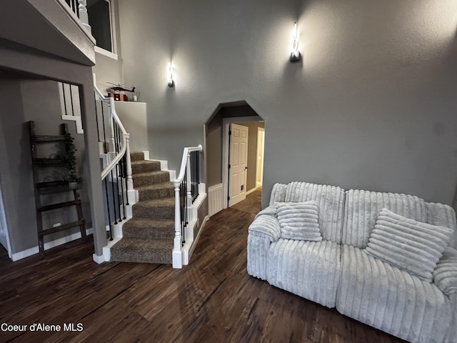 10320 N Payment Peak Rd, Hauser, ID 83854 - living area featuring wood finished floors, stairs, baseboards, and arched walkways