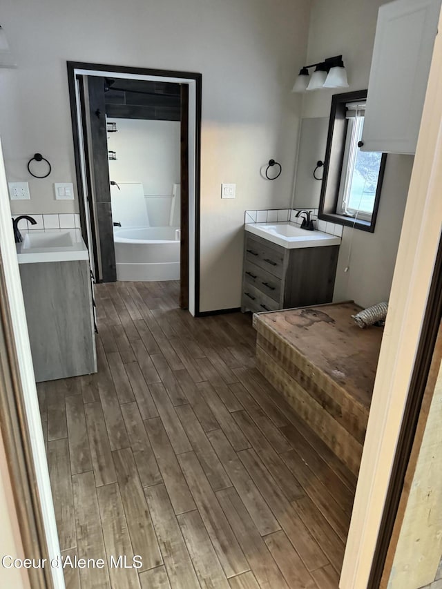 10320 N Payment Peak Rd, Hauser, ID 83854 - full bath with wood finished floors, vanity, and a tub to relax in