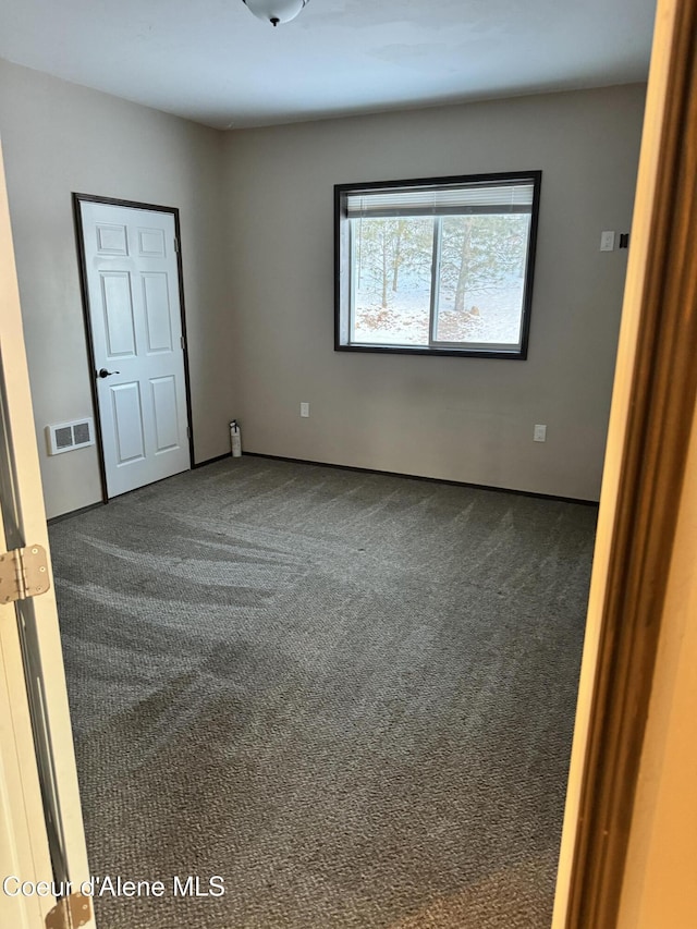 10320 N Payment Peak Rd, Hauser, ID 83854 - spare room with dark colored carpet