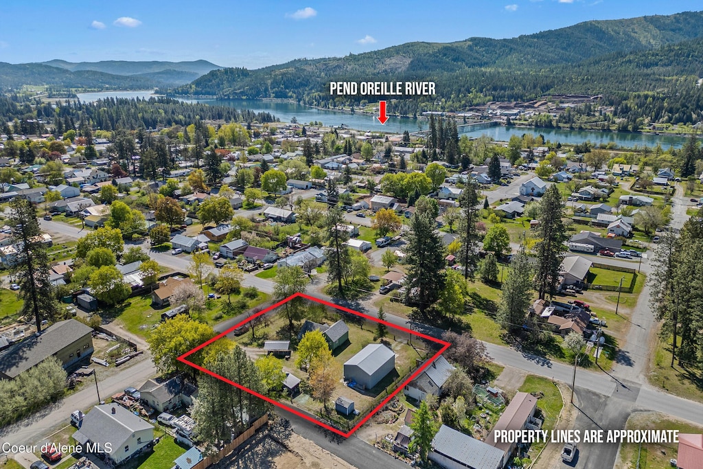 99 E Lincoln Ave, Priest River, ID 83856 - view of property location with a water and mountain view, property parcel outlined, and a heavily wooded area