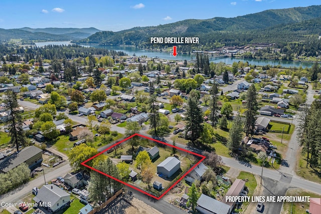99 E Lincoln Ave, Priest River, ID 83856 - view of property location with a water and mountain view, property parcel outlined, and a heavily wooded area
