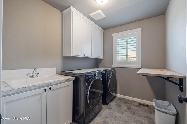 7102 S Hever St, Cheney, WA 99004 - laundry area featuring cabinet space, washer and clothes dryer, and baseboards