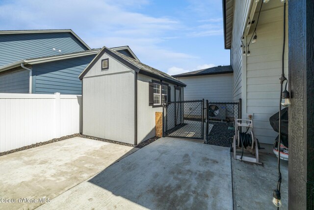 7102 S Hever St, Cheney, WA 99004 - view of patio with a gate, fence, and an outbuilding