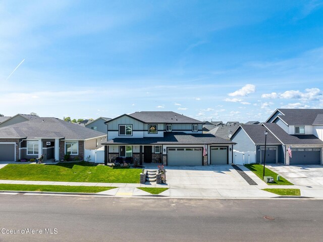 7102 S Hever St, Cheney, WA 99004 - view of front facade with driveway, a residential view, stone siding, and an attached garage
