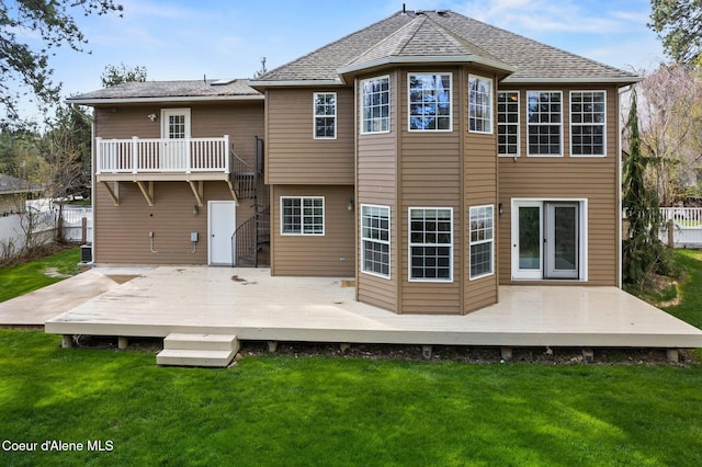 2123 Browning Way, Sandpoint, ID 83864 - rear view of property featuring fence, a deck, and a lawn