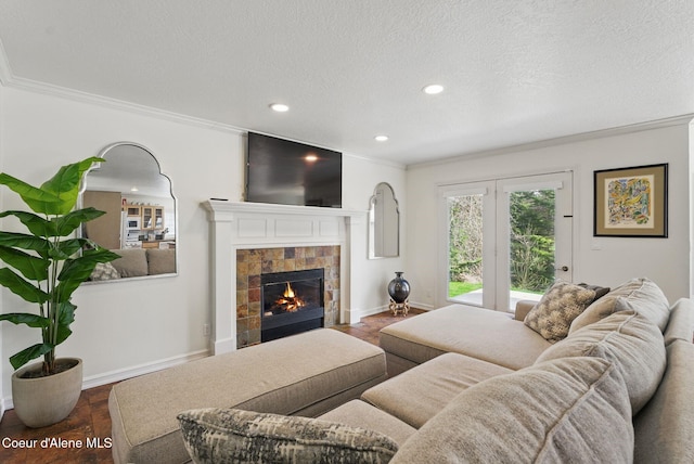 2123 Browning Way, Sandpoint, ID 83864 - living room featuring baseboards, ornamental molding, a tiled fireplace, and a textured ceiling