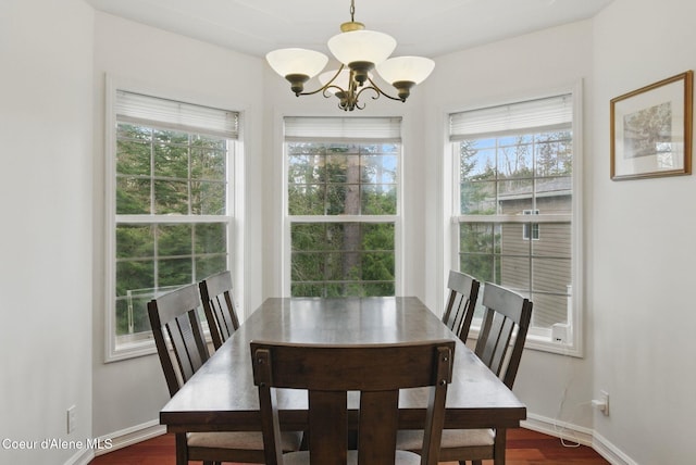 2123 Browning Way, Sandpoint, ID 83864 - dining area featuring baseboards, dark wood finished floors, and a chandelier
