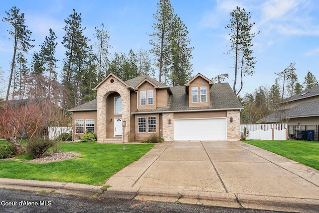 2123 Browning Way, Sandpoint, ID 83864 - traditional-style home with driveway, a front lawn, fence, and an attached garage