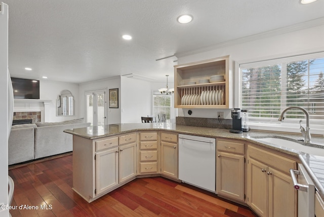 2123 Browning Way, Sandpoint, ID 83864 - kitchen featuring a peninsula, dishwasher, a healthy amount of sunlight, and a sink