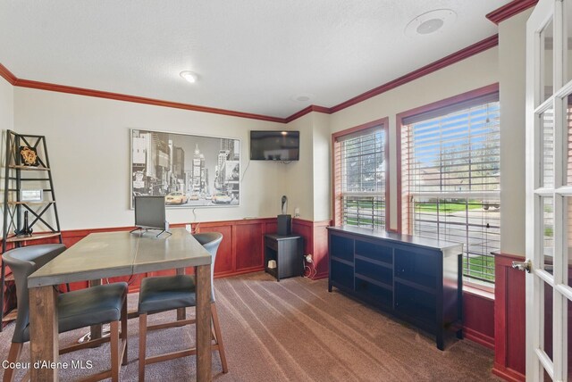 2123 Browning Way, Sandpoint, ID 83864 - carpeted dining space with ornamental molding and a wainscoted wall