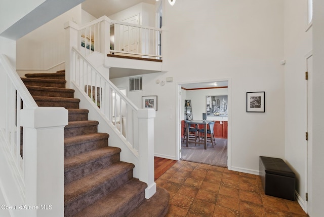 2123 Browning Way, Sandpoint, ID 83864 - stairway featuring a towering ceiling, visible vents, baseboards, and stone finish flooring