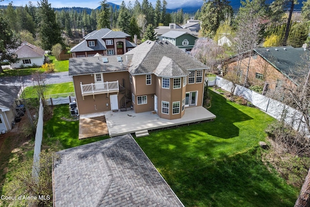 2123 Browning Way, Sandpoint, ID 83864 - rear view of house with a fenced backyard, a wooden deck, a yard, and a residential view