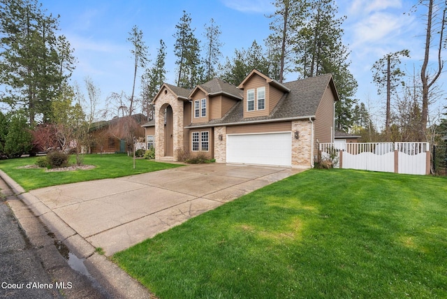 2123 Browning Way, Sandpoint, ID 83864 - traditional home featuring fence, concrete driveway, a front yard, brick siding, and roof with shingles