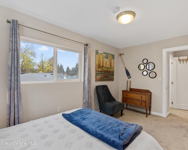 bedroom featuring carpet and baseboards