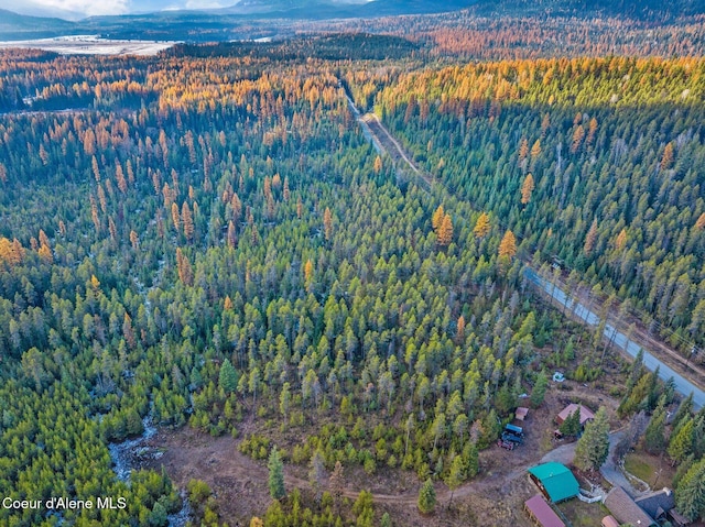 762 Reeder Bay Rd, Nordman, ID 83848 - aerial overview of property's location featuring a heavily wooded area and a mountain backdrop