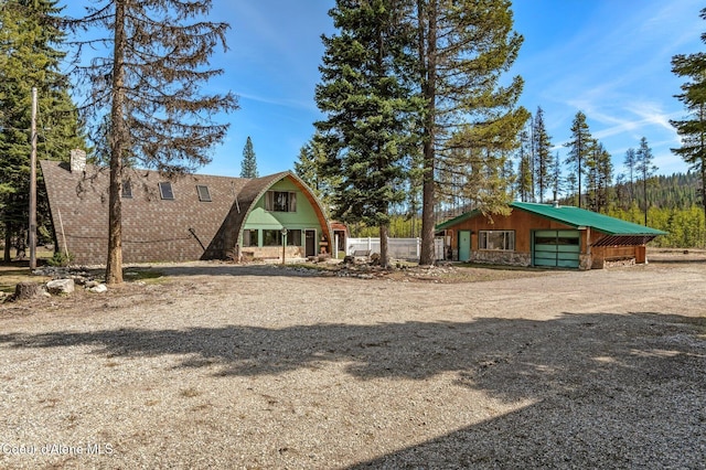 762 Reeder Bay Rd, Nordman, ID 83848 - view of yard featuring a garage, an outbuilding, and driveway
