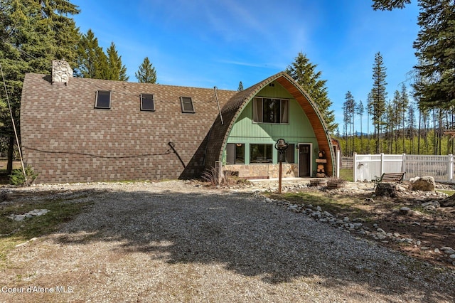 762 Reeder Bay Rd, Nordman, ID 83848 - rear view of property featuring fence and a chimney
