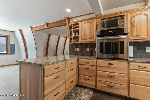 762 Reeder Bay Rd, Nordman, ID 83848 - kitchen featuring stainless steel appliances, decorative backsplash, a peninsula, and stone countertops